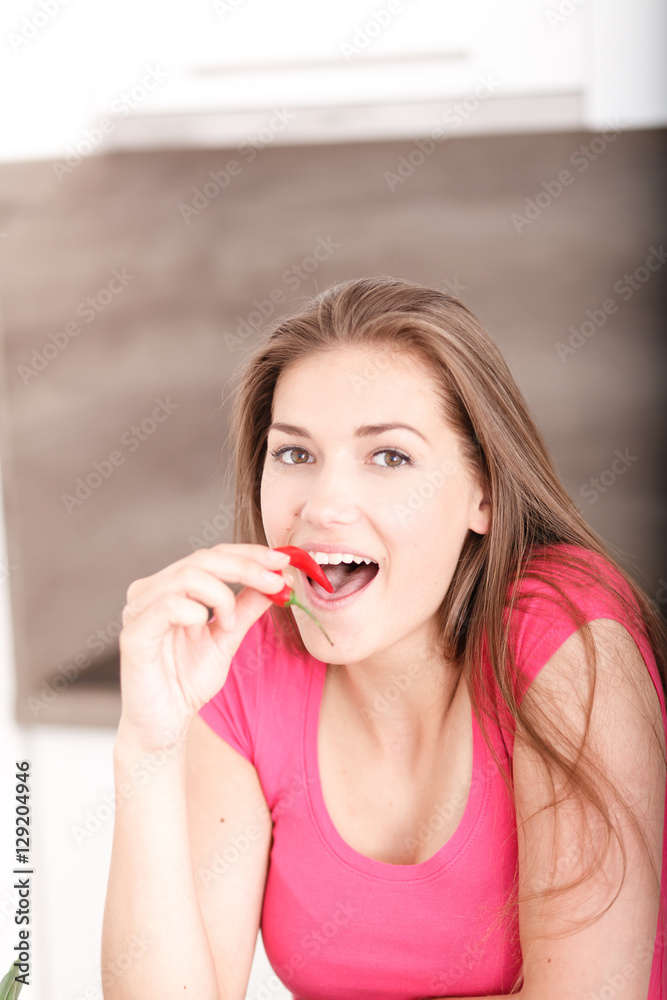 Portrait of a beautiful young girl with chili pepper. Portrait of a beautiful young girl with chili pepper.