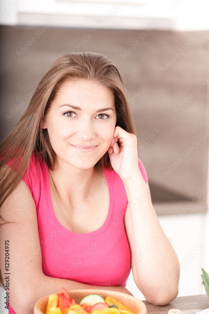 Portrait of a beautiful young girl in the kitchen. Portrait of a beautiful young girl in the kitchen.