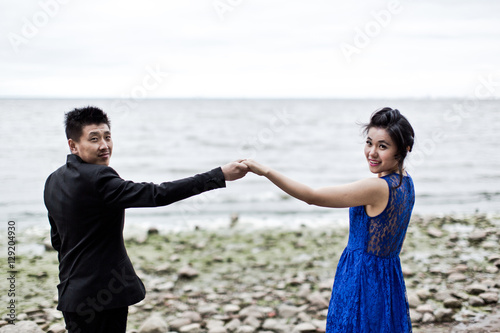 Bride and groom on their wedding day outdoors. Chinese bride in a blue dress