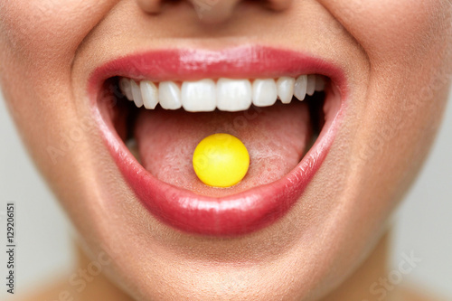 Beautiful Woman Mouth With Pill On Tongue. Girl Taking Medicine