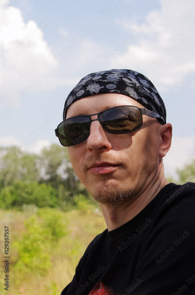 Man in dark glasses and a bandana on his head Man in dark glasses and a bandana on his head