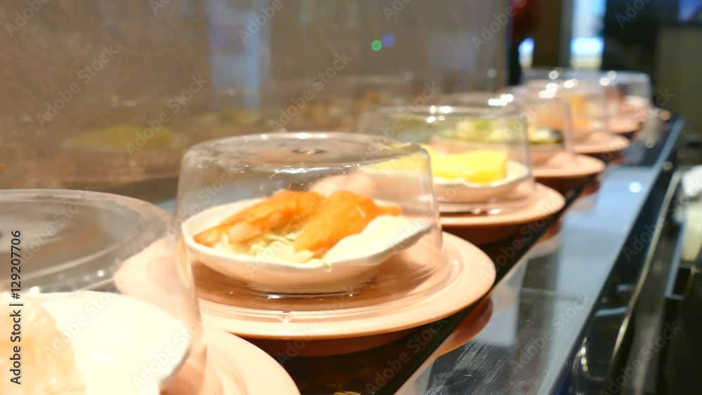 Sushi on conveyor belt in restaurant Sushi on conveyor belt in restaurant