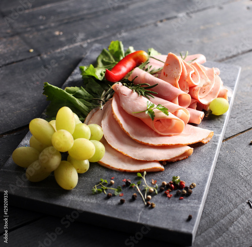 cold meat plate. Sliced ham with lettuce, shallow depth, selective focus