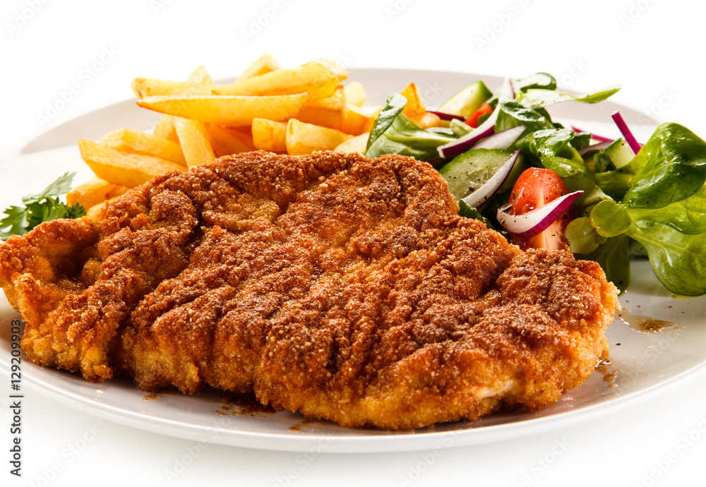 Fried pork chop, French fries and vegetables Fried pork chop, French fries and vegetables
