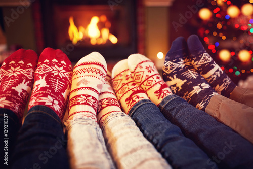 Family in socks near fireplace in winter.