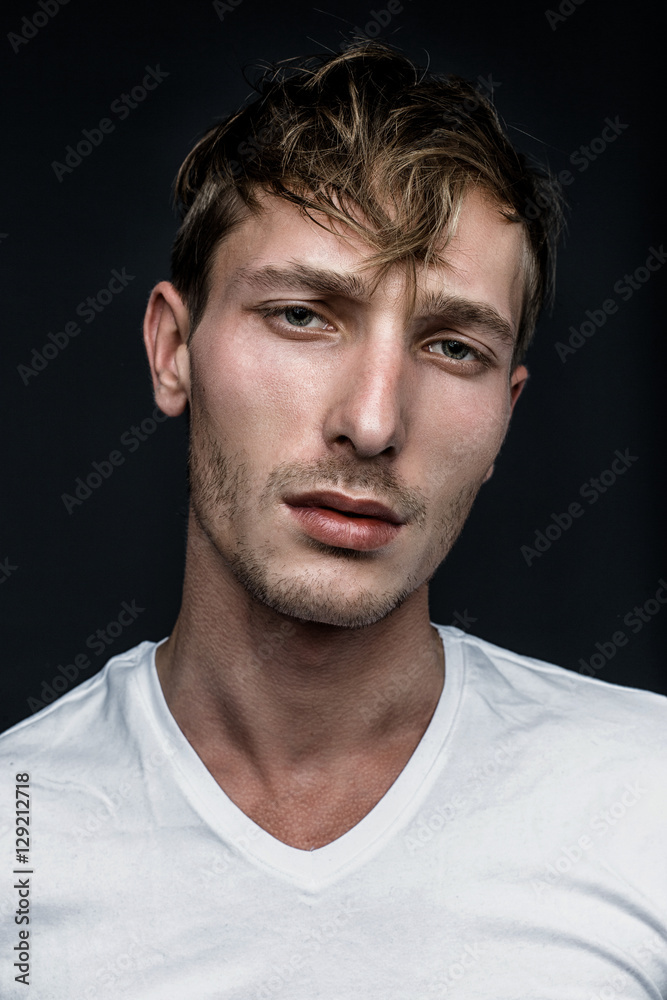 handsome young man in white t shirt posing in studio handsome young man in white t shirt posing in studio