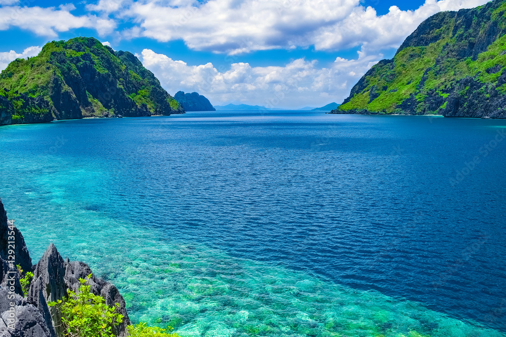 Beautiful tropical sea bay. Scenic landscape with mountain islands and blue lagoon, El Nido, Palawan, Philippines, Southeast Asia. Exotic scenery. Popular landmark, famous destination of Philippines Beautiful tropical sea bay. Scenic landscape with mountain islands and blue lagoon, El Nido, Palawan, Philippines, Southeast Asia. Exotic scenery. Popular landmark, famous destination of Philippines