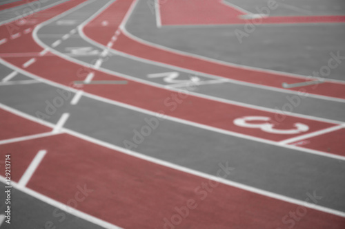 Blurred image of running track with numbers from 1 to 3. Red color isolated. Curves of a Running Track. 