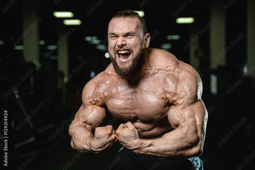 Brutal strong bodybuilder athletic men pumping up muscles with d Brutal strong bodybuilder athletic men pumping up muscles with d