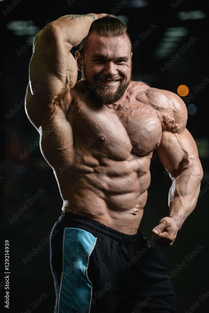 Brutal strong bodybuilder athletic men pumping up muscles with d Brutal strong bodybuilder athletic men pumping up muscles with d