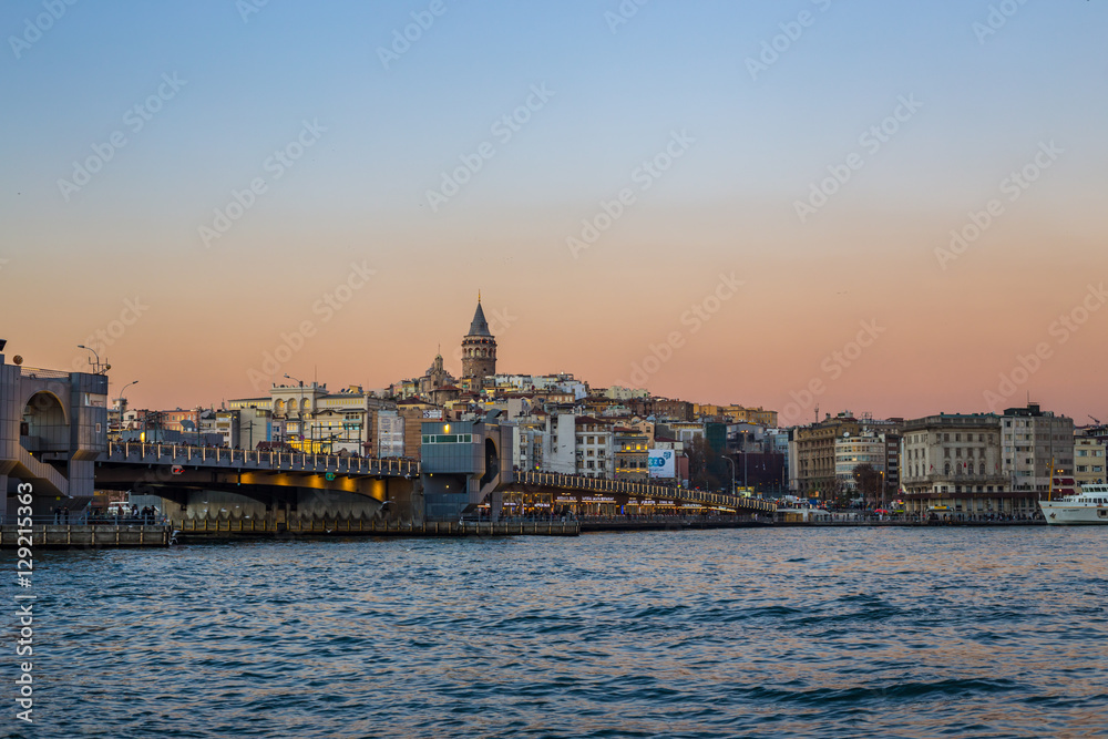 Sunset view of Galata tower and Galata bridge over the Bosphorus channel, Istanbul, Turkey