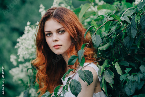 young red-haired woman in a forest 