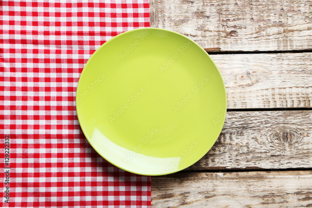 Empty plate with napkin on brown wooden table Empty plate with napkin on brown wooden table