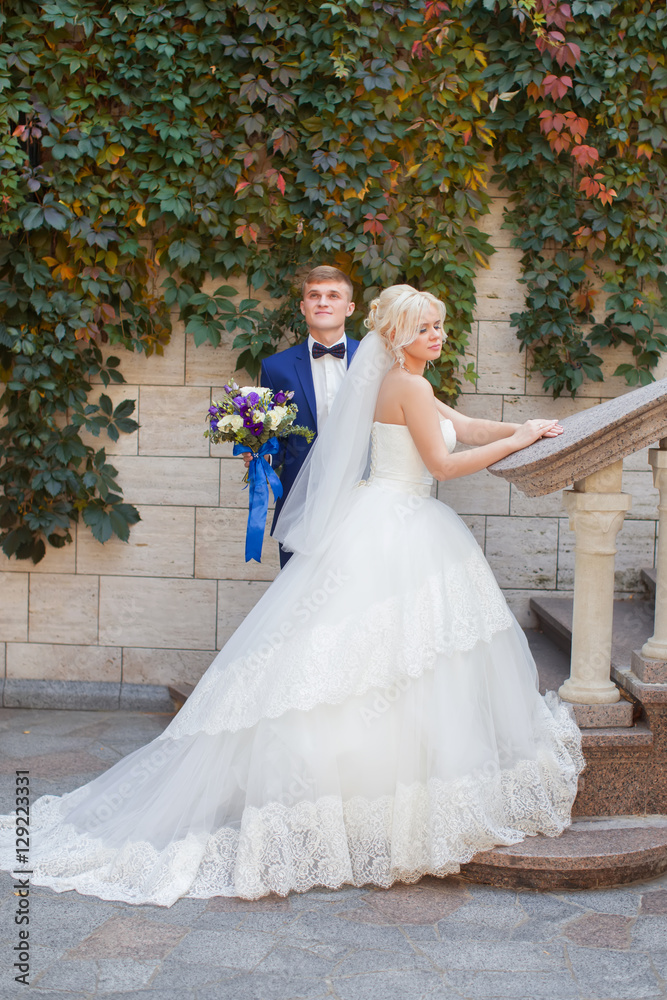 Stylish newlyweds posing for a walk in the photo Stylish newlyweds posing for a walk in the photo