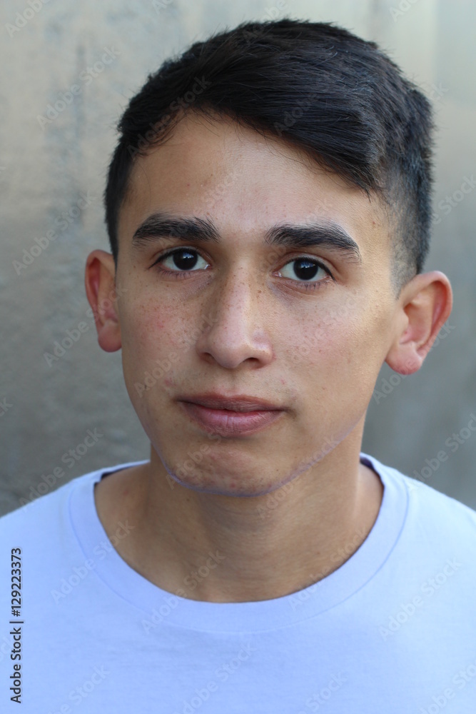 Obraz premium Serious Latino teen outdoors close up