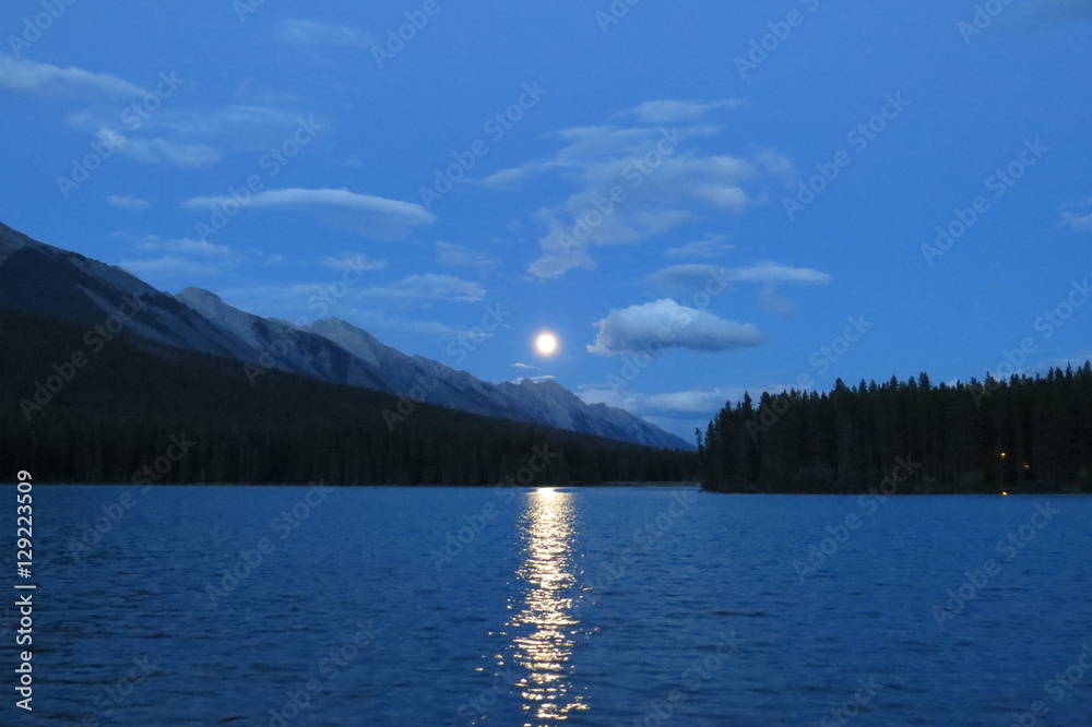 Moonrise that create a light bridge on the lake. Banff, Canada.