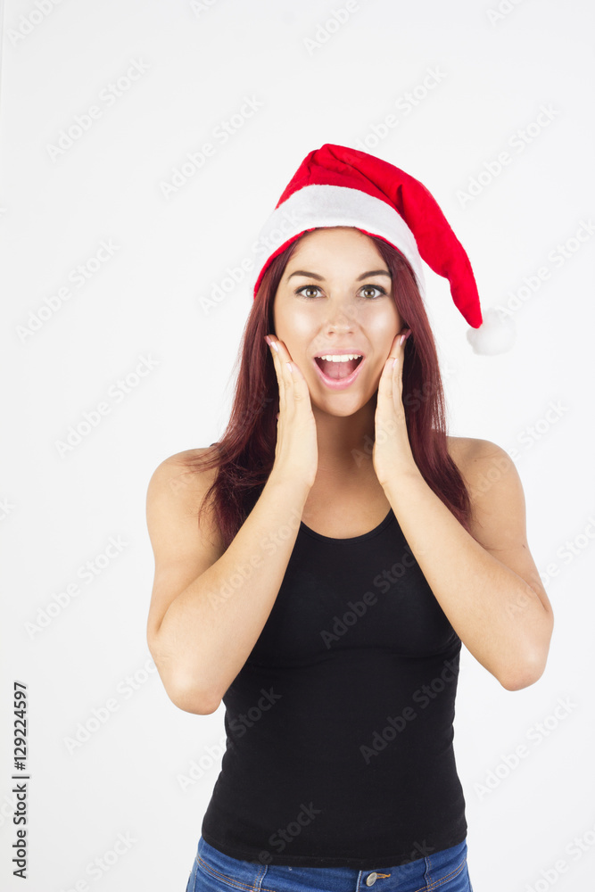 Surprised woman in santa hat on white background. Surprised happy christmas woman Surprised woman in santa hat on white background. Surprised happy christmas woman