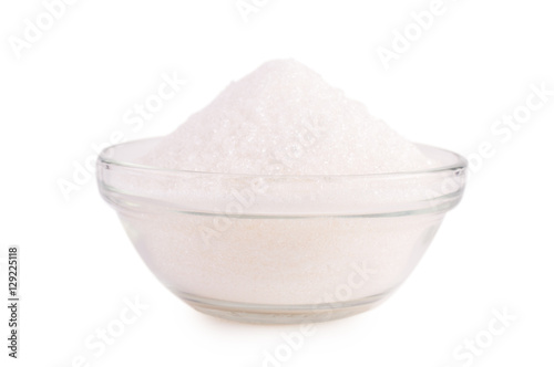 Sugar in glass bowl isolated on white