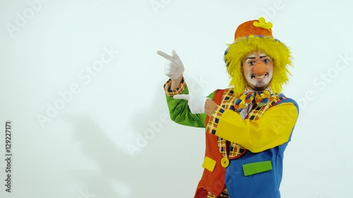 Smiling colorful clown showing the good way to go
