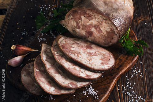 Sliced pork saltisons on cutting board photo