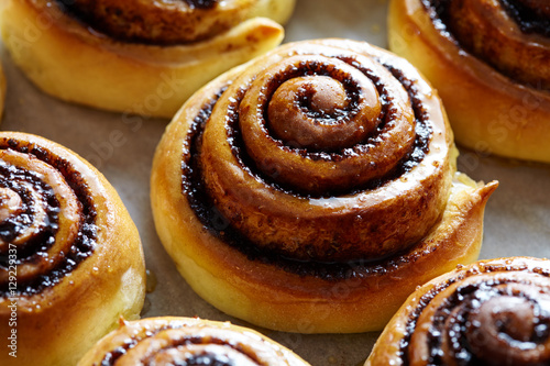 Sweet rolls with cinnamon and cocoa filling. Cinnabon roll bread, homemade bakery. Christmas baking pastry. Kanelbulle - swedish dessert.
