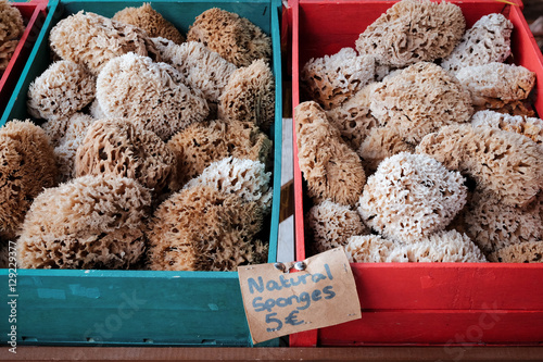 natual sponges in red and blue wooden boxes with price tag on sa