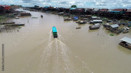 Aerial view of fishing and tour boats navigating through Kampong Khleang in Cambodia, one of the many villages along Tonle Sap lake in southeast Asia