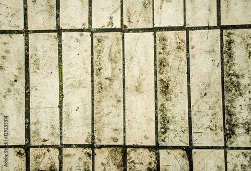 Stone pavement texture. Granite cobblestoned pavement background. Abstract background of old cobblestone pavement close-up.