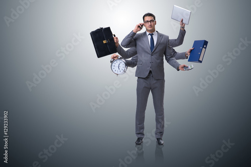 Young businessman in multitasking concept