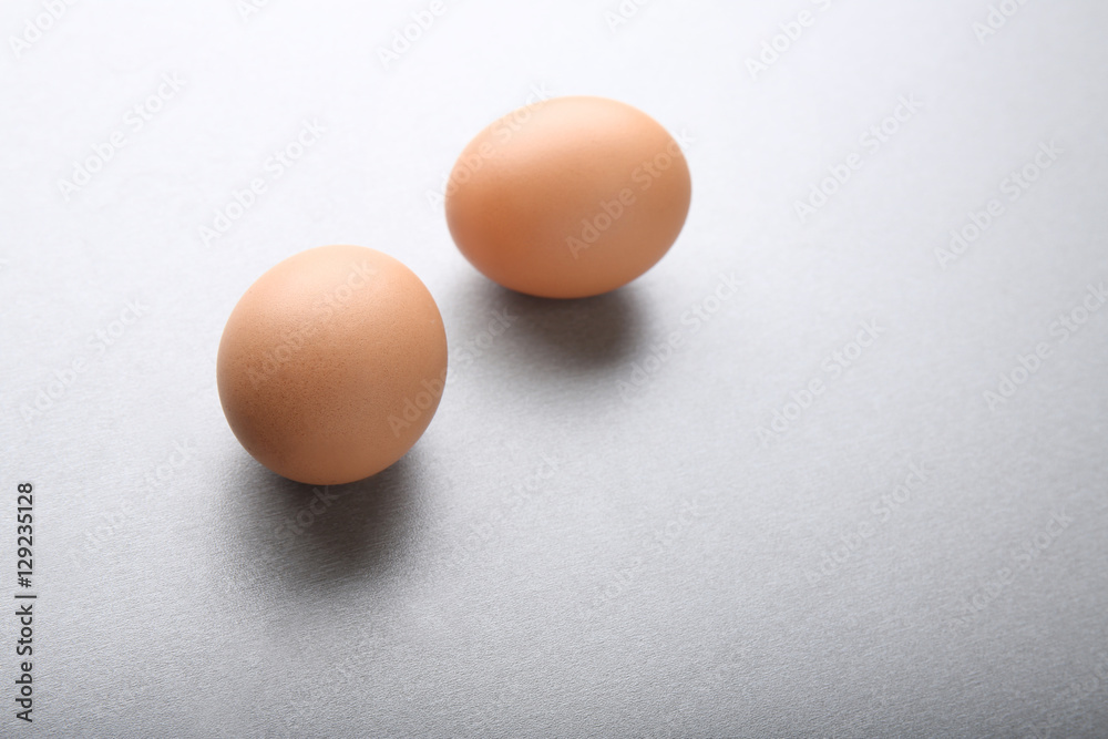 Raw eggs on grey background Raw eggs on grey background
