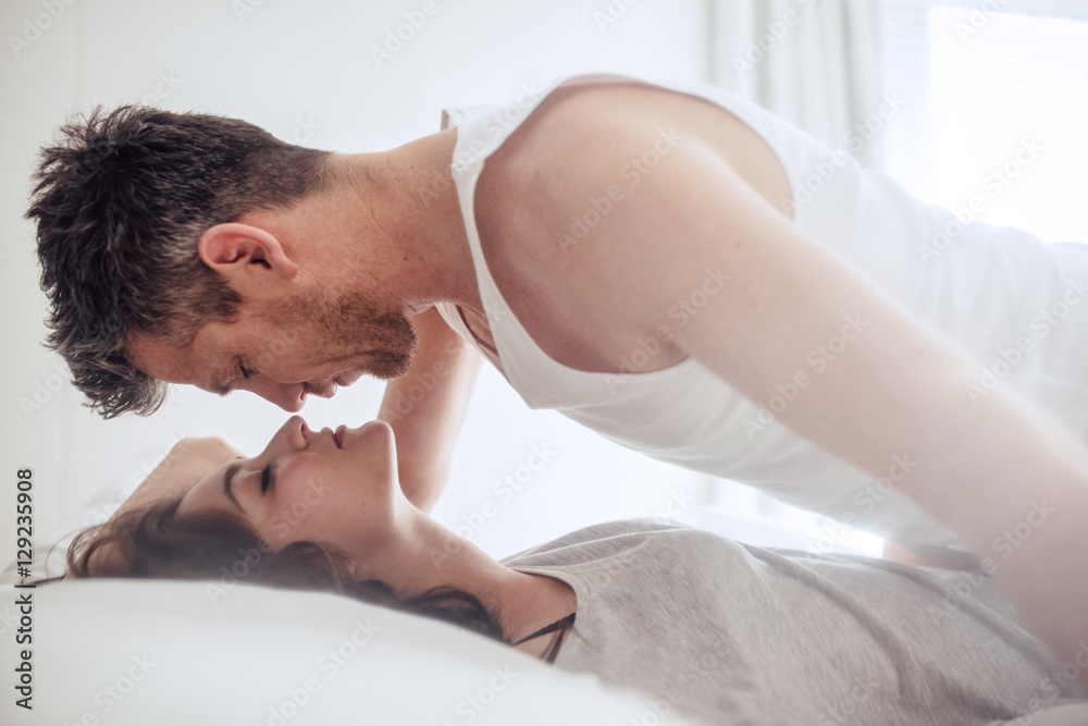 Intimate young couple during foreplay in bed Stock Photo | Adobe Stock