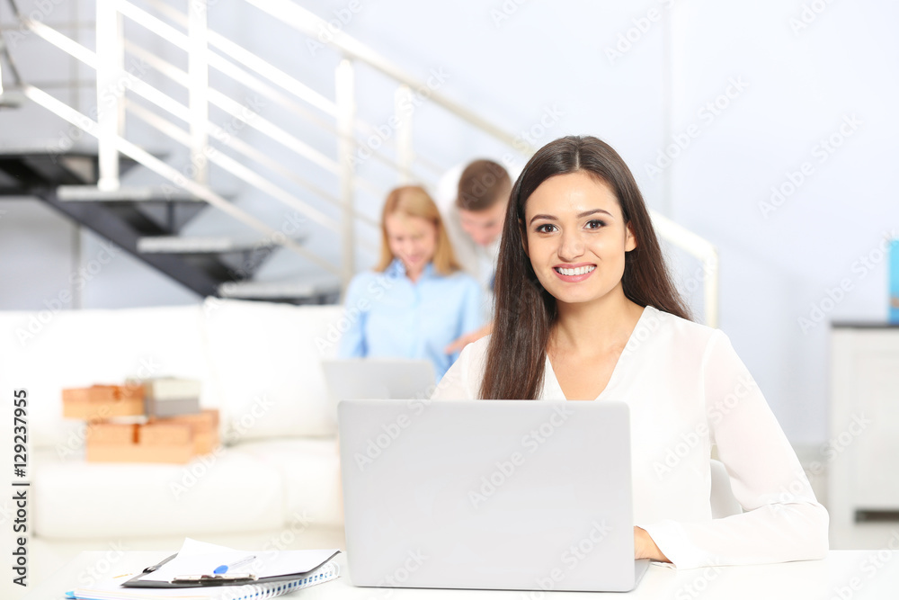 Beautiful young woman working with laptop in office Beautiful young woman working with laptop in office