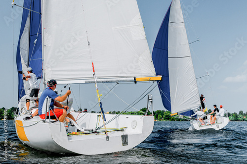 Sailing yacht race, regatta. Team athletes participating in the sailing competition