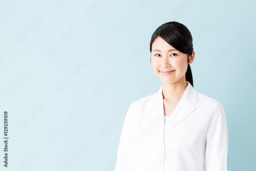portrait of young asian nurse isolated on blue background portrait of young asian nurse isolated on blue background