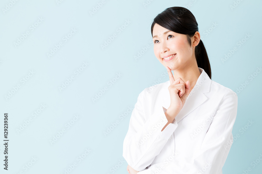 portrait of young asian nurse isolated on blue background portrait of young asian nurse isolated on blue background