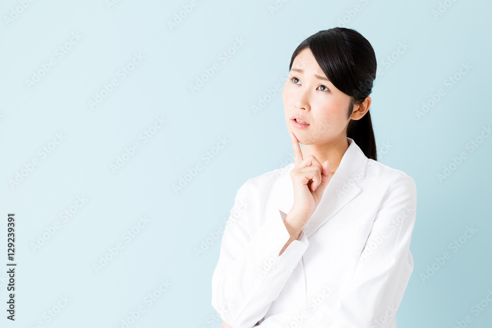 portrait of young asian nurse isolated on blue background portrait of young asian nurse isolated on blue background