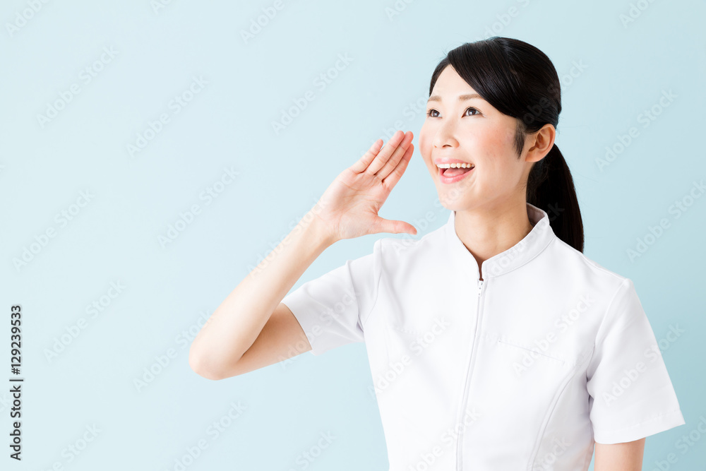 portrait of young asian nurse isolated on blue background portrait of young asian nurse isolated on blue background
