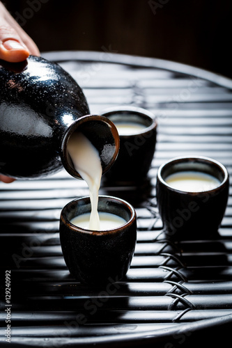 Ready to drink sake in black ceramics on black table