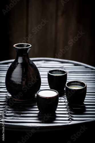 Delicious sake in black ceramics on black table