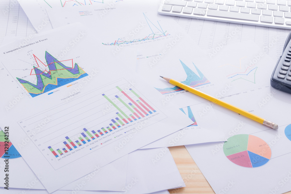 Documents report data graphs with calculator on office desk Documents report data graphs with calculator on office desk