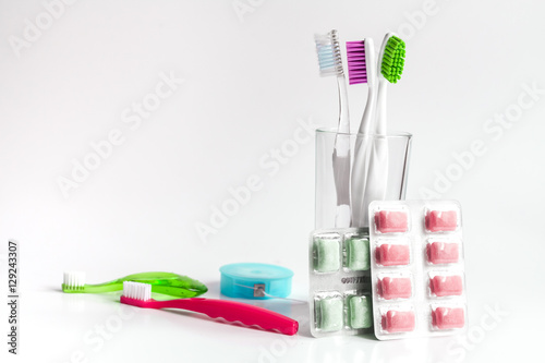 toothbrushes in glass on white background tools for oral care