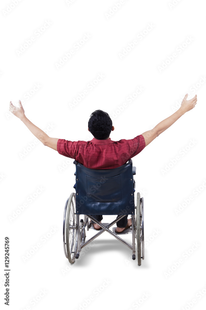 Handicapped man raising hands in the studio Handicapped man raising hands in the studio