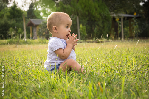 happy young baby child sittng on grass on beautiful summer day i © Andriy Petrenko
