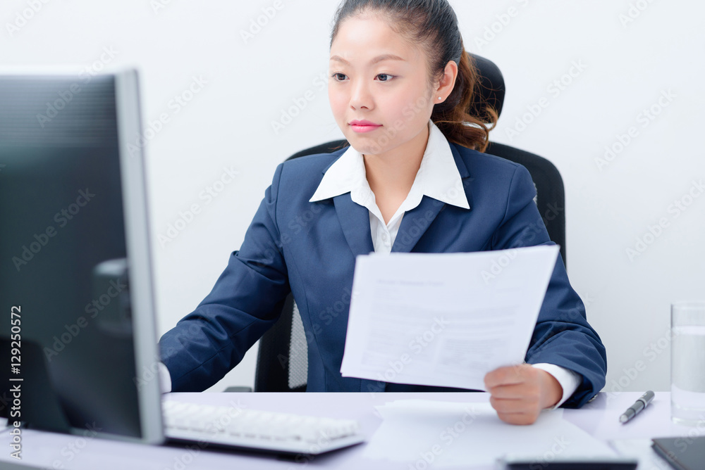 Young businesswoman working on computer. Young businesswoman working on computer.