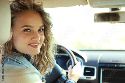 Young female driver in car ...