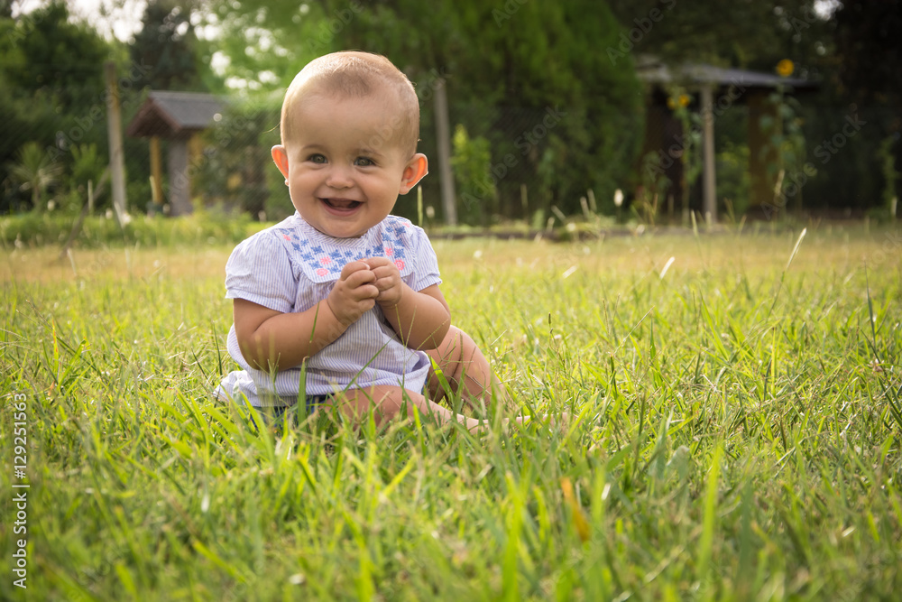 happy young baby child sittng on grass on beautiful summer day i happy young baby child sittng on grass on beautiful summer day i