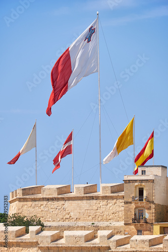 The flags flap over the fortress walls for a holiday. Malta photo