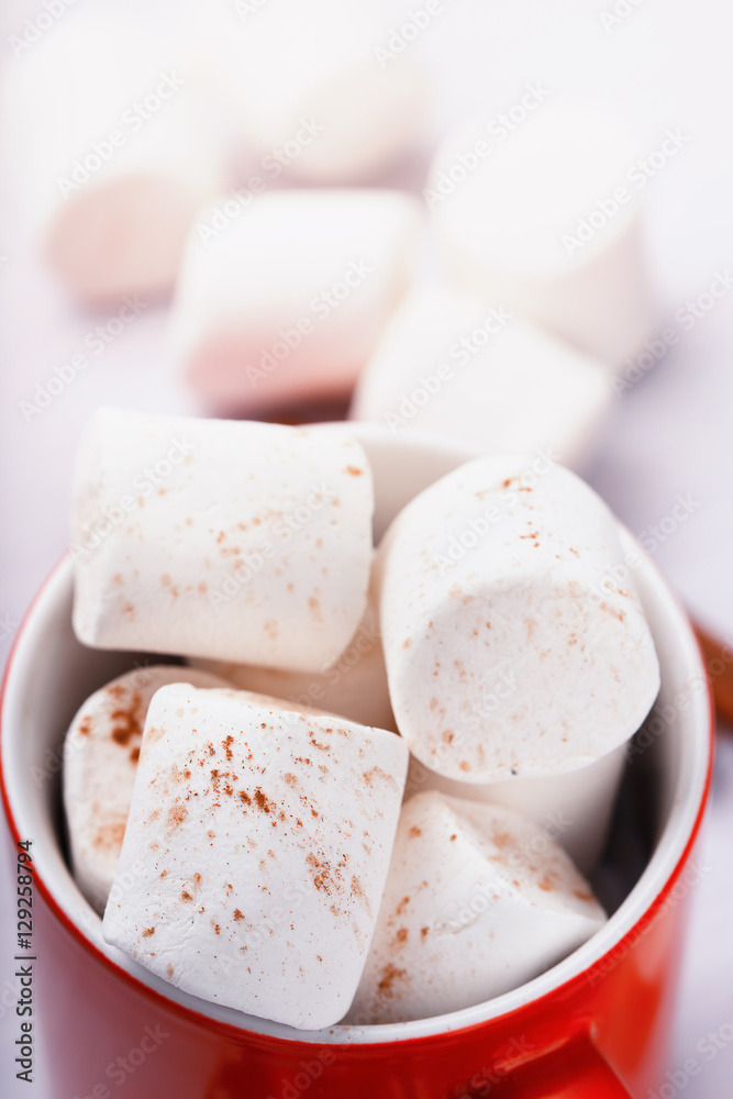 Marshmallows with chocolate in red cup, close-up Marshmallows with chocolate in red cup, close-up