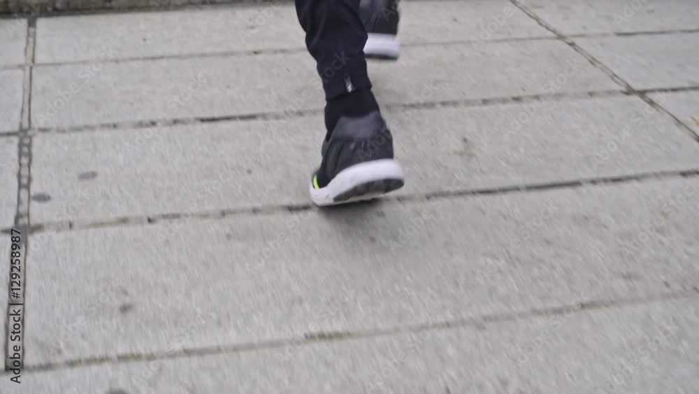 Tracking with low section of male legs running up stairs Tracking with low section of male legs running up stairs