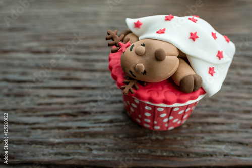 christmas theme cup cake on wooden background